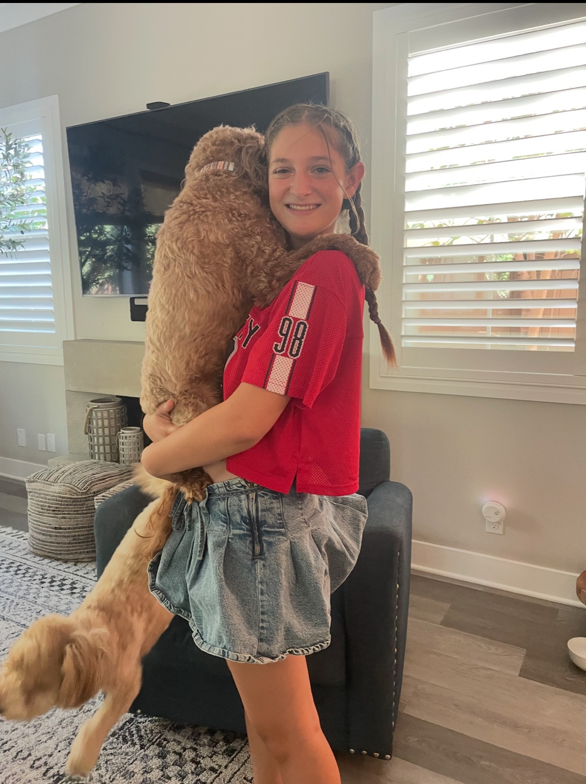 Teen girl holding a larger fluffy dog