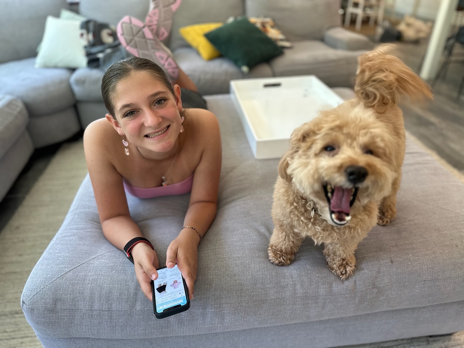 Teen girl smiling and holding a fluffy dog
