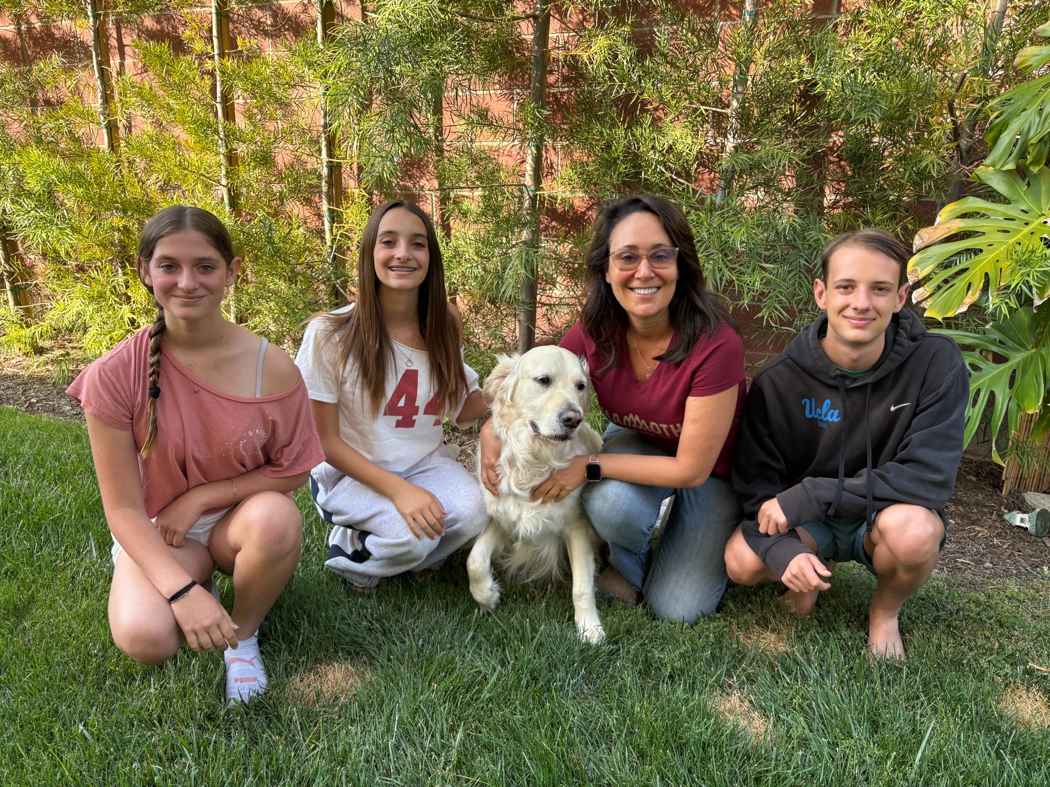 Rossi family with their dog in the backyard