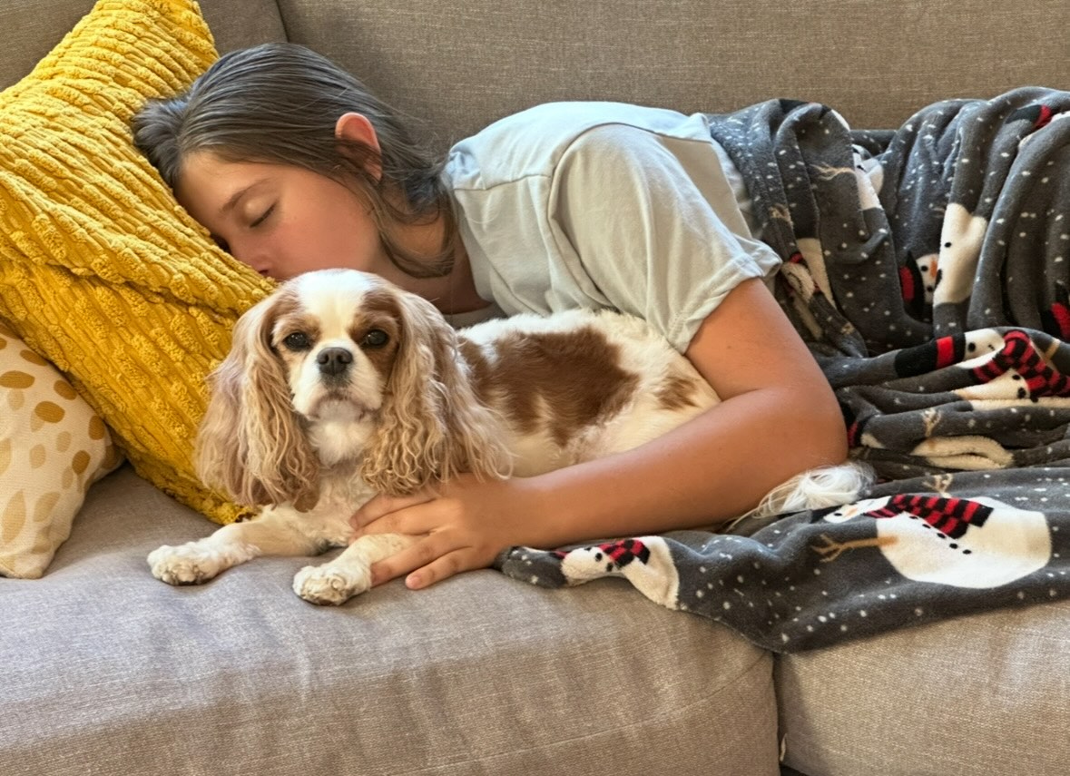 Teen girl holding a larger fluffy dog