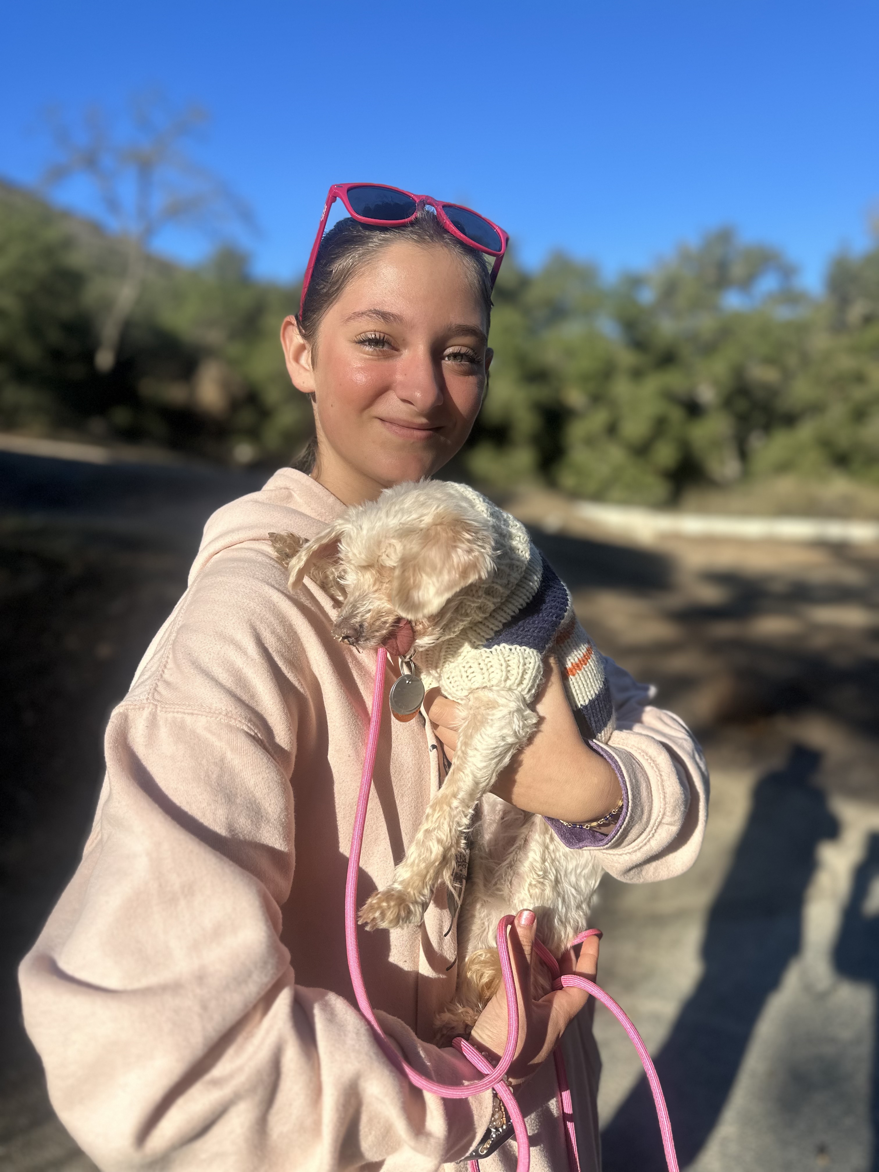 Teen girl holding a small dog